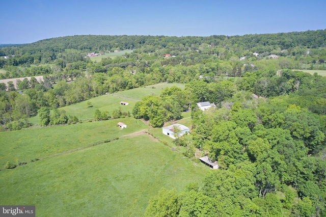 view of property location featuring a forest