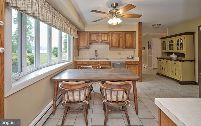 kitchen with a sink, dishwasher, healthy amount of natural light, and baseboard heating