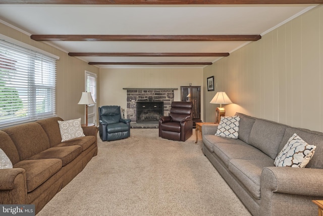 carpeted living room with beamed ceiling, a stone fireplace, and crown molding