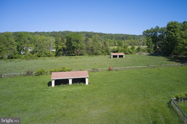 view of rural area with a forest