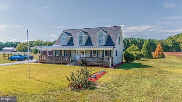 20852 Country Rd, Georgetown, DE 19947 - view of front facade featuring covered porch, a front yard, metal roof, and a standing seam roof