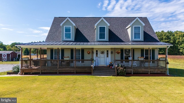 20852 Country Rd, Georgetown, DE 19947 - farmhouse featuring a standing seam roof, a porch, a front lawn, and metal roof