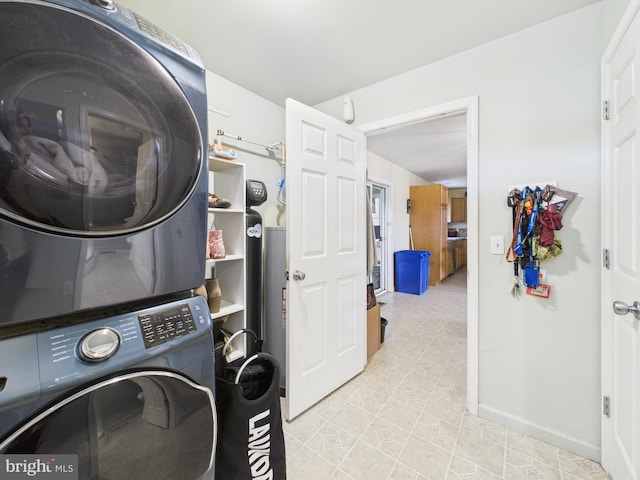 20852 Country Rd, Georgetown, DE 19947 - laundry room with stacked washer and clothes dryer, light tile patterned floors, and baseboards