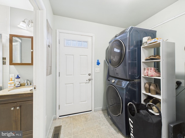 20852 Country Rd, Georgetown, DE 19947 - washroom featuring estacked washer and dryer, baseboards, and light tile patterned flooring