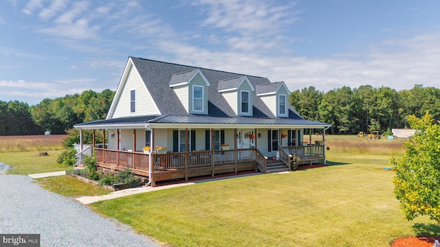 20852 Country Rd, Georgetown, DE 19947 - farmhouse featuring covered porch, a front yard, metal roof, a standing seam roof, and a shingled roof
