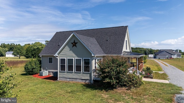 20852 Country Rd, Georgetown, DE 19947 - rear view of property featuring a lawn, roof with shingles, and driveway