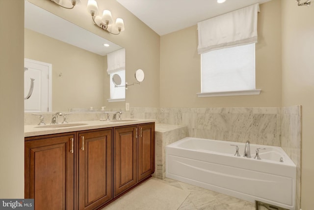 full bath featuring marble look tiles, a bath, and double vanity