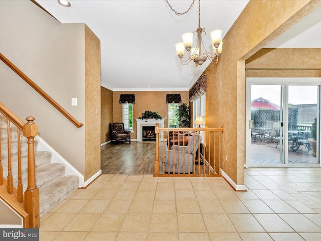 13241 Manor Dr S, Mount Airy, MD 21771 - foyer featuring baseboards, a chandelier, stairway, crown molding, and a fireplace