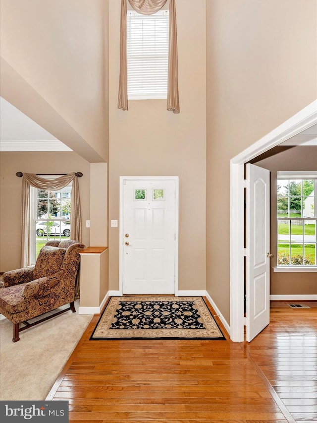 13241 Manor Dr S, Mount Airy, MD 21771 - entryway with a high ceiling, wood-type flooring, baseboards, and crown molding