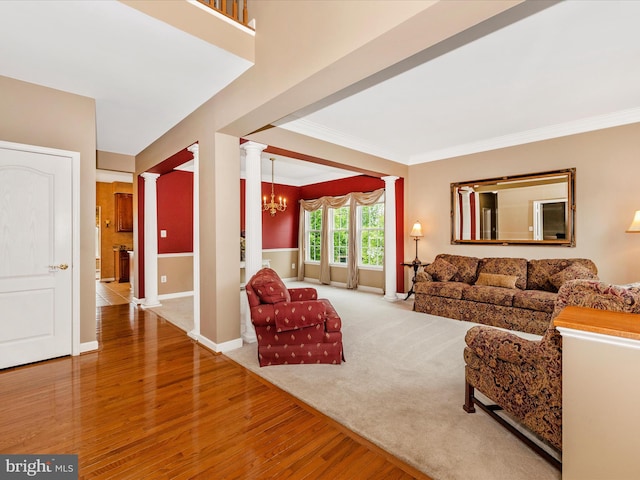 13241 Manor Dr S, Mount Airy, MD 21771 - living room with decorative columns, wood finished floors, a chandelier, crown molding, and baseboards