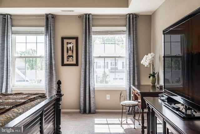 living area featuring carpet and baseboards