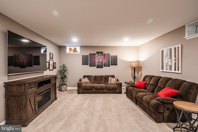 carpeted living room with baseboards