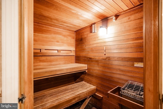 relaxing sauna / steam room featuring wood walls and wood ceiling
