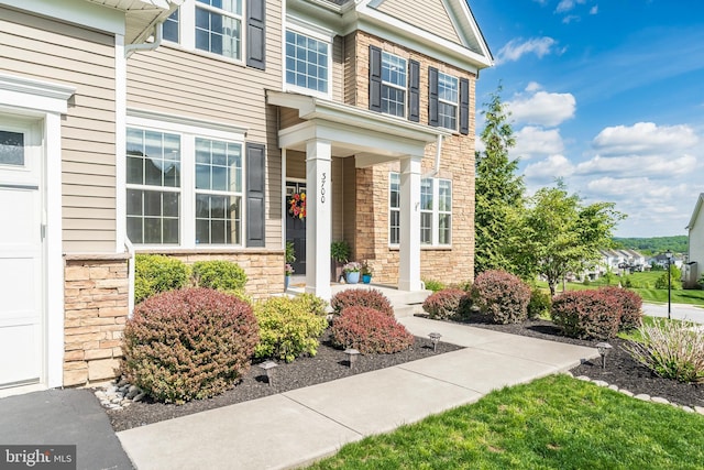 property entrance featuring stone siding and a porch
