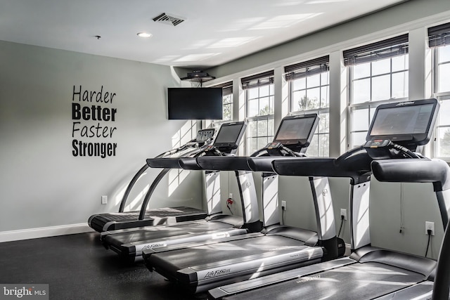 exercise room with baseboards and recessed lighting