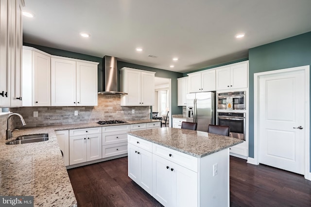 kitchen with stainless steel fridge with ice dispenser, a sink, wall chimney exhaust hood, gas cooktop, and dark wood-type flooring
