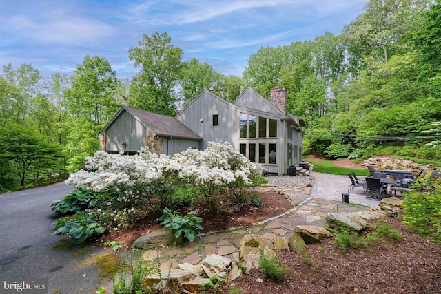 18 Beethoven Dr, Wilmington, DE 19807 - back of property featuring a chimney and a patio