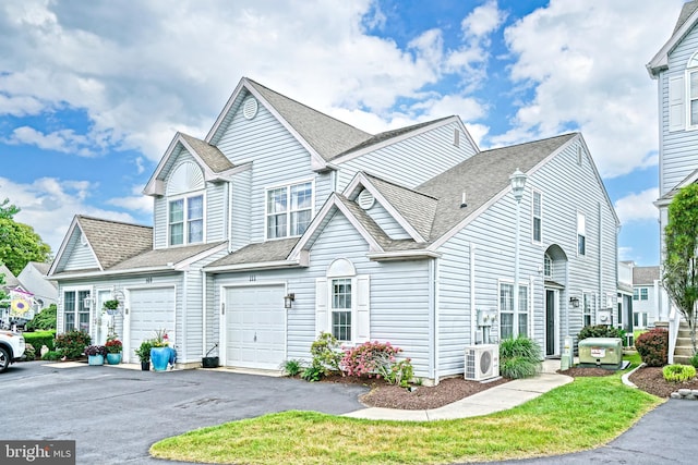 111 Seabright Way Unit E3, Rehoboth Beach, DE 19971 - view of property featuring ac unit, a garage, asphalt driveway, and a shingled roof