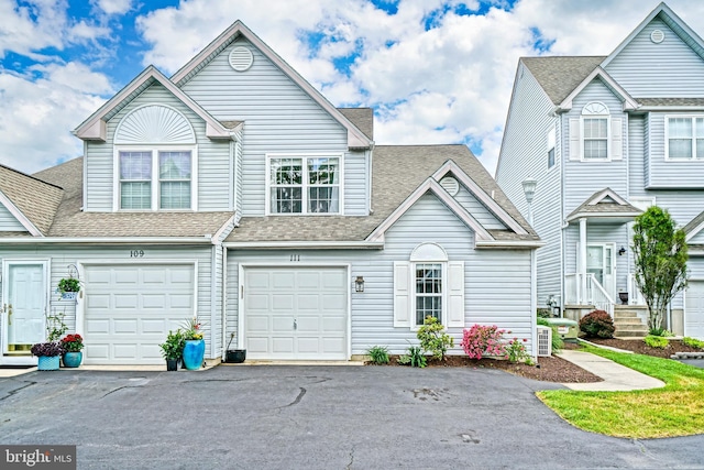111 Seabright Way Unit E3, Rehoboth Beach, DE 19971 - multi unit property featuring driveway, a shingled roof, and an attached garage