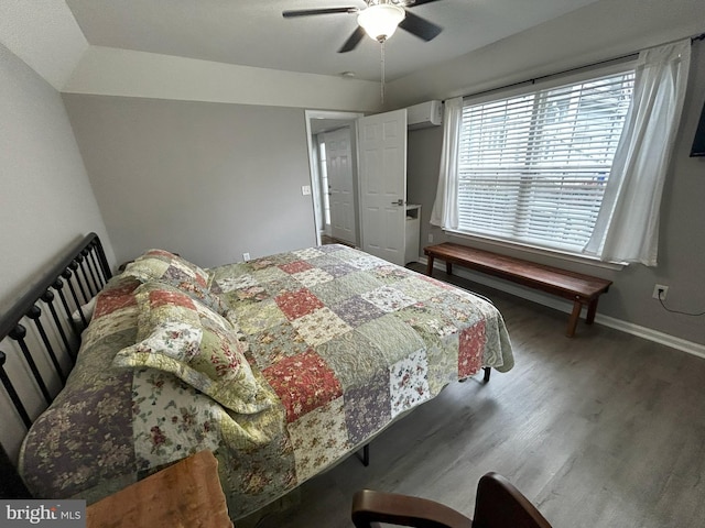 111 Seabright Way Unit E3, Rehoboth Beach, DE 19971 - bedroom featuring a wall unit AC, wood finished floors, and a ceiling fan