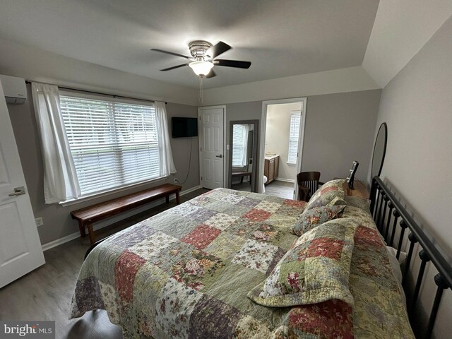 111 Seabright Way Unit E3, Rehoboth Beach, DE 19971 - bedroom featuring a wall mounted air conditioner, wood finished floors, multiple windows, and baseboards