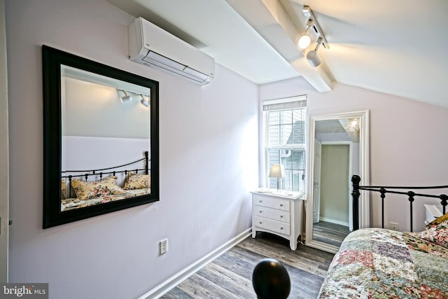 111 Seabright Way Unit E3, Rehoboth Beach, DE 19971 - bedroom with an AC wall unit, wood finished floors, track lighting, lofted ceiling, and baseboards