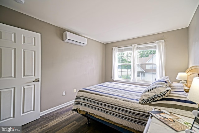 111 Seabright Way Unit E3, Rehoboth Beach, DE 19971 - bedroom with a wall unit AC, dark wood-type flooring, and baseboards
