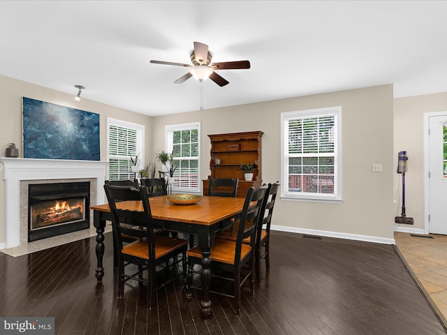 1904 Artillery Ln, Odenton, MD 21113 - dining room featuring ceiling fan, a fireplace with flush hearth, healthy amount of natural light, and wood-type flooring
