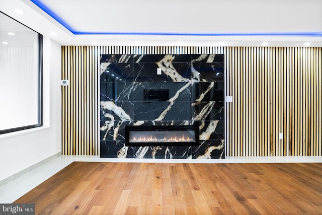 cinema featuring wood finished floors, recessed lighting, and a high end fireplace