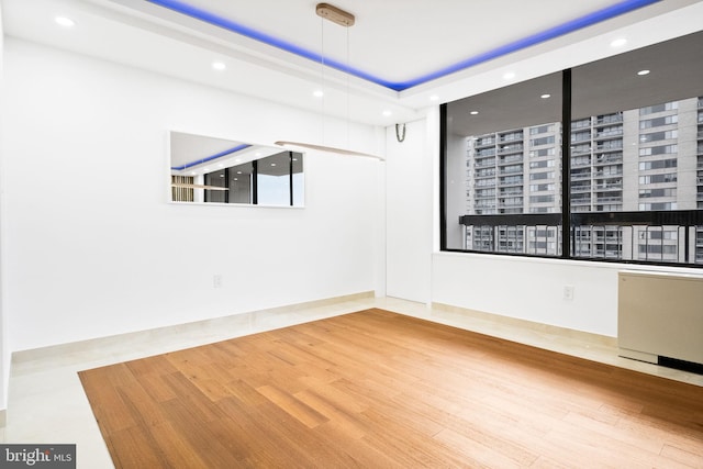 unfurnished room featuring radiator heating unit, recessed lighting, and wood finished floors