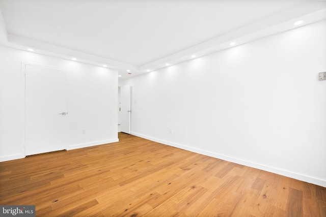 below grade area with recessed lighting, light wood-style floors, and baseboards