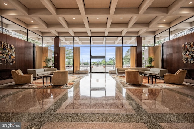 community lobby featuring a towering ceiling, recessed lighting, coffered ceiling, and beamed ceiling