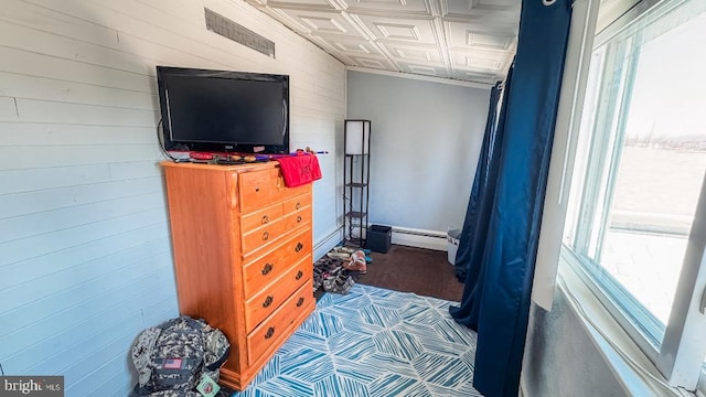 648 E 3rd St, Bloomsburg, PA 17815 - bedroom featuring an ornate ceiling, wood walls, and a baseboard heating unit