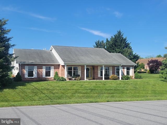 ranch-style home with brick siding and a front lawn