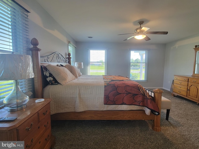 carpeted bedroom featuring ceiling fan and baseboards
