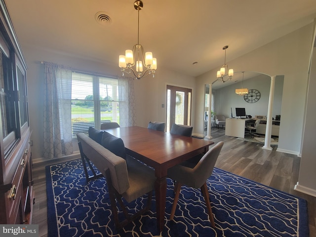 dining space with a chandelier, wood finished floors, baseboards, arched walkways, and lofted ceiling