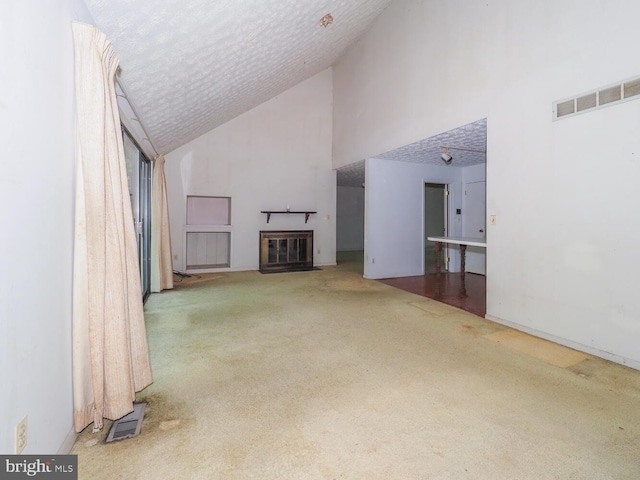 524 Ridge Rd, Annapolis, MD 21401 - unfurnished living room with carpet floors, a fireplace with flush hearth, high vaulted ceiling, and a textured ceiling