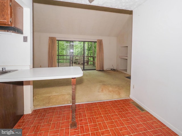 524 Ridge Rd, Annapolis, MD 21401 - kitchen with lofted ceiling, baseboards, dark carpet, light countertops, and a peninsula