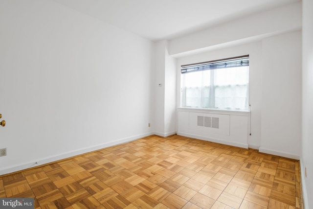 unfurnished room featuring baseboards