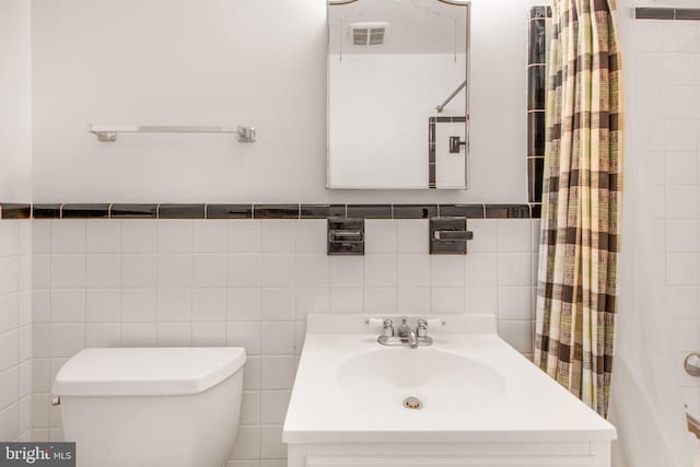 full bathroom featuring tile walls, toilet, a shower with shower curtain, and vanity