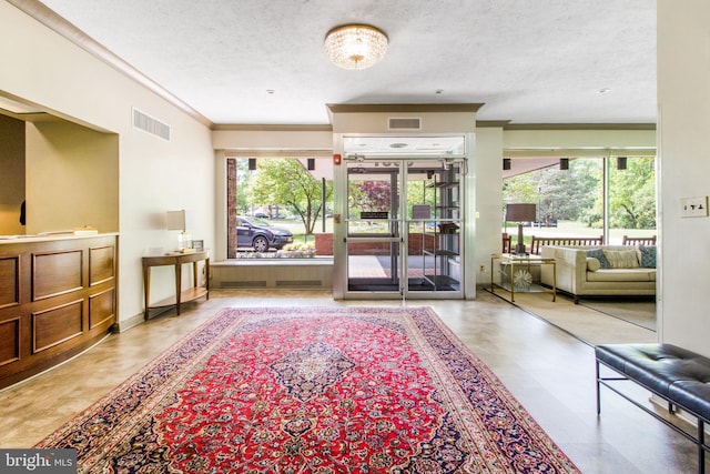 community lobby featuring crown molding and a textured ceiling