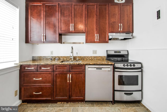 kitchen with dishwasher, under cabinet range hood, stainless steel range with electric stovetop, a sink, and reddish brown cabinets