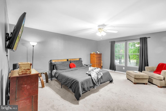 bedroom with carpet flooring, baseboards, and ceiling fan