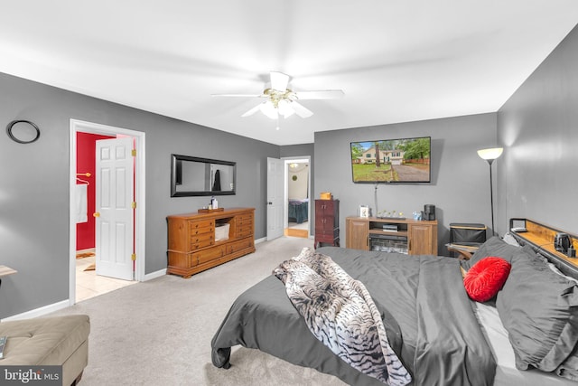 bedroom featuring carpet flooring, baseboards, connected bathroom, and ceiling fan