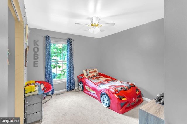 bedroom with carpet flooring, baseboards, and a ceiling fan