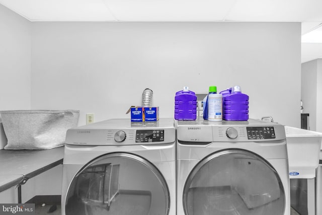 laundry area featuring washing machine and clothes dryer