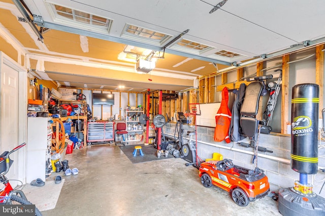 garage with a workshop area and a garage door opener