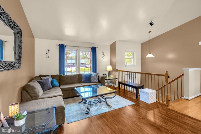 living room featuring wood finished floors and lofted ceiling