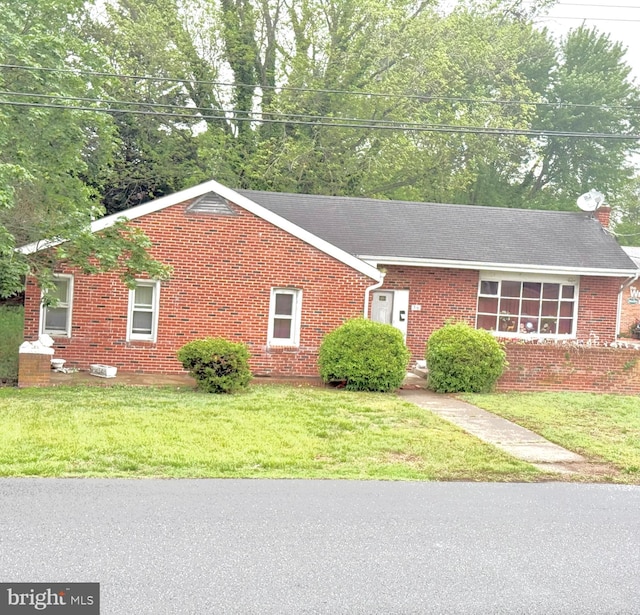 single story home with brick siding and a front lawn