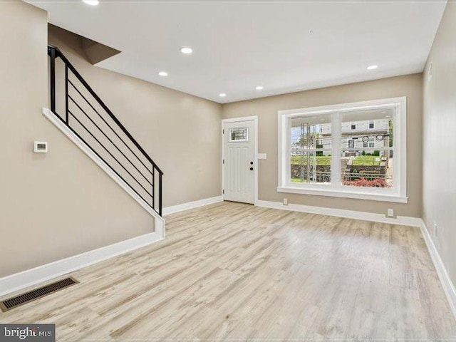 foyer entrance with wood finished floors, stairs, baseboards, and recessed lighting